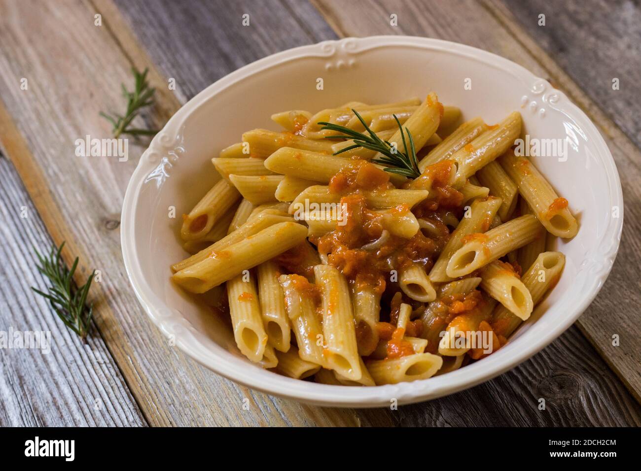 Pasta with pumpkin on wooden background. Selective focus Stock Photo