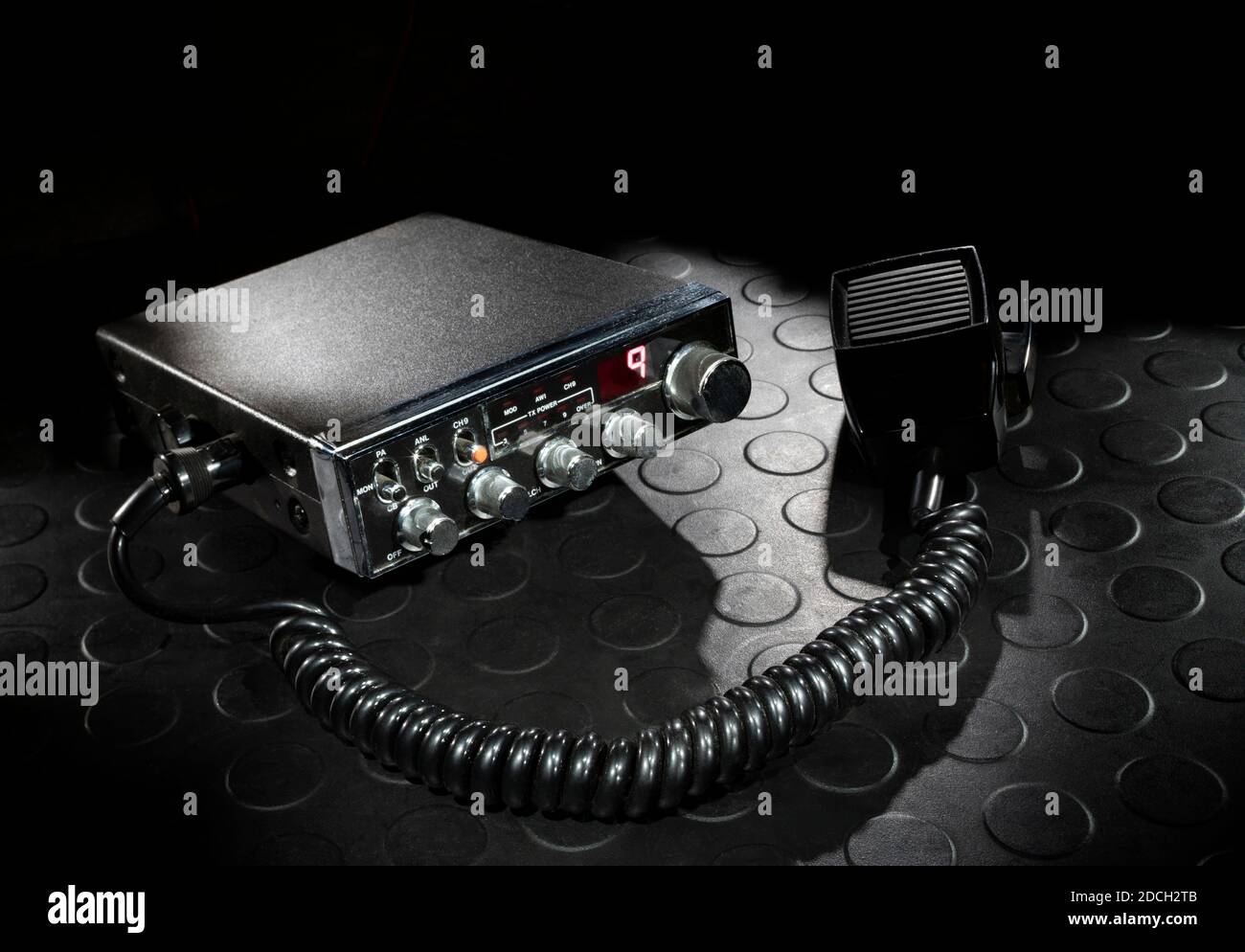Two way radio on the emergency channel with a dark background on a