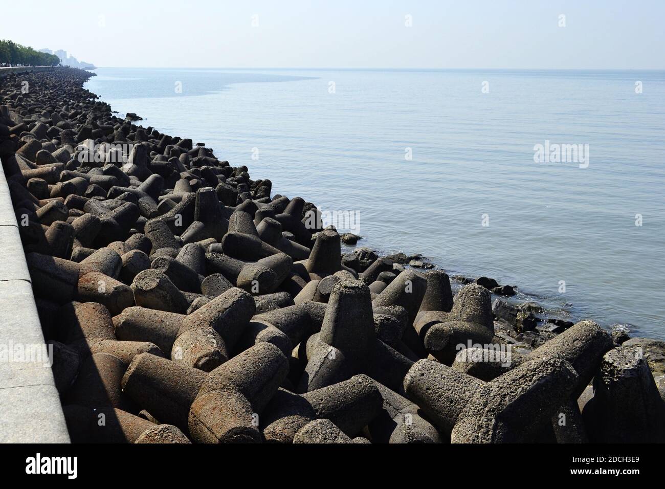 Concrete wave breakers along promenade on coastline near Marine drive road. Back Bay is part of Arabian sea near Mumbai, India. Stock Photo