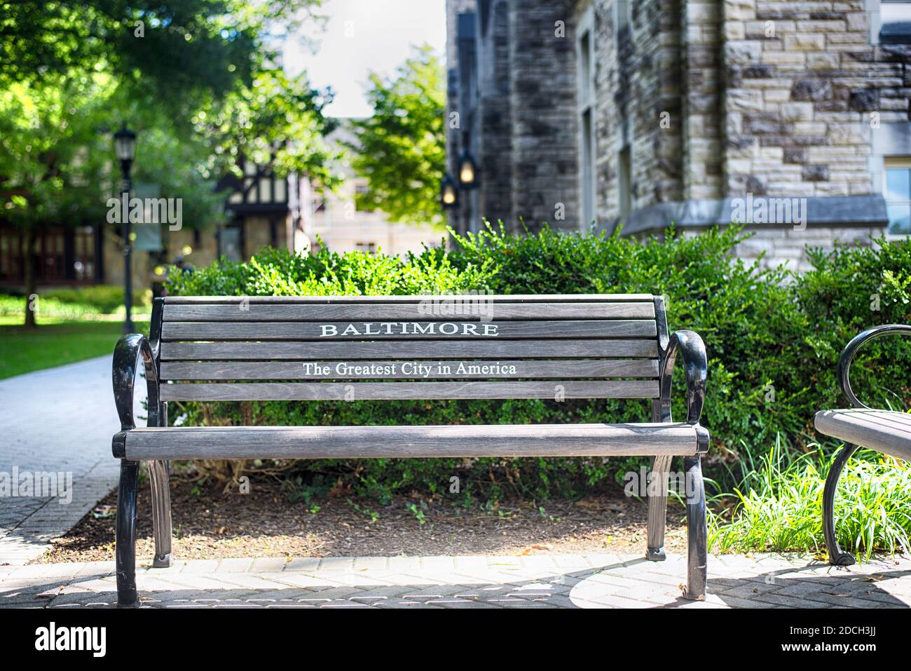 a bench on the evergreen campus at Loyola University Baltimore Maryland in the summer. Stock Photo