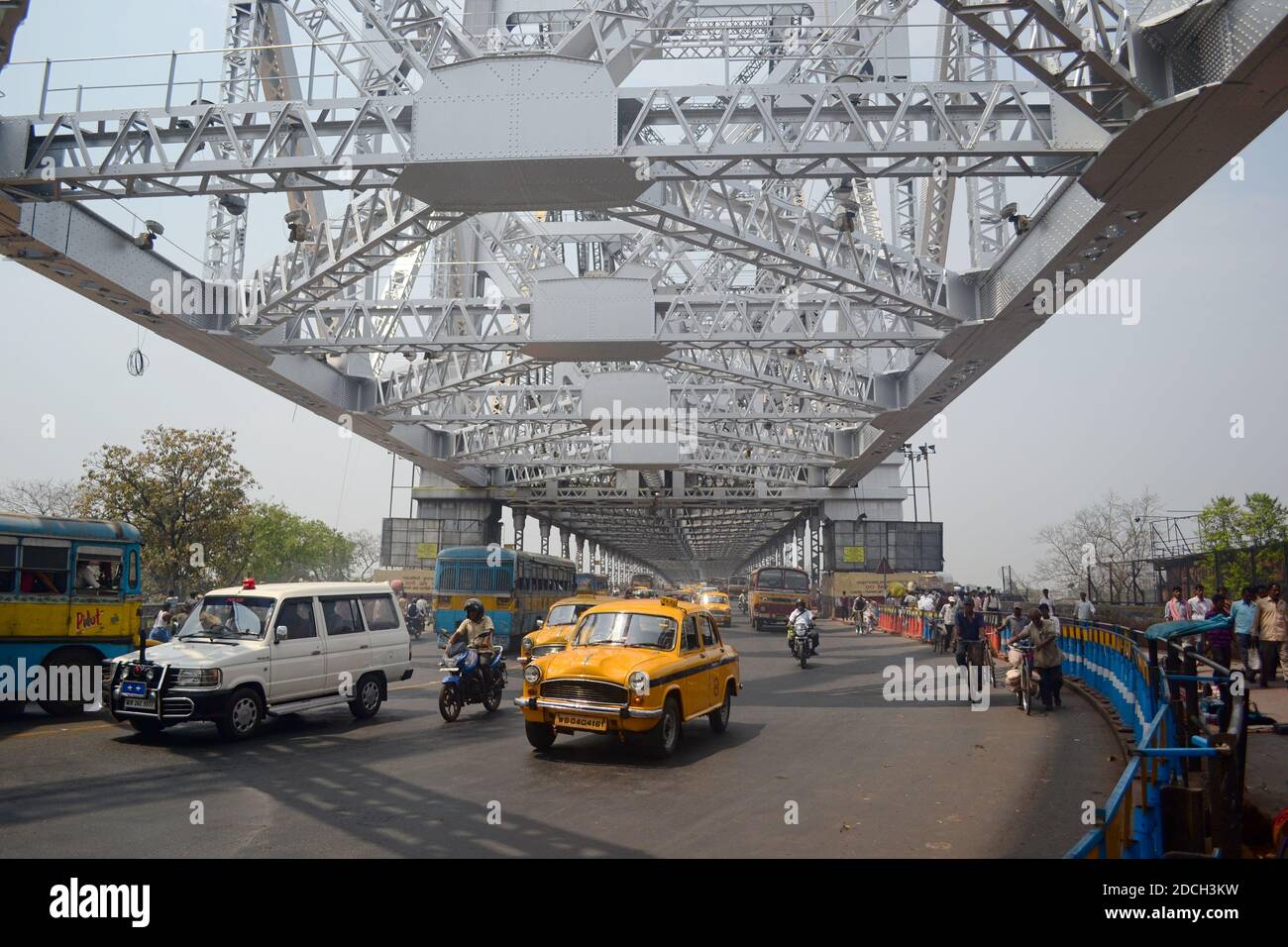 Kolkata, India - March, 2014: Cars, motorbikes and other transport vehicles on the Howrah bridge Stock Photo