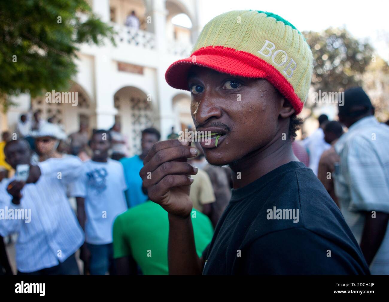 Young rasta man chewing qat in the street, Lamu County, Lamu, Kenya Stock Photo