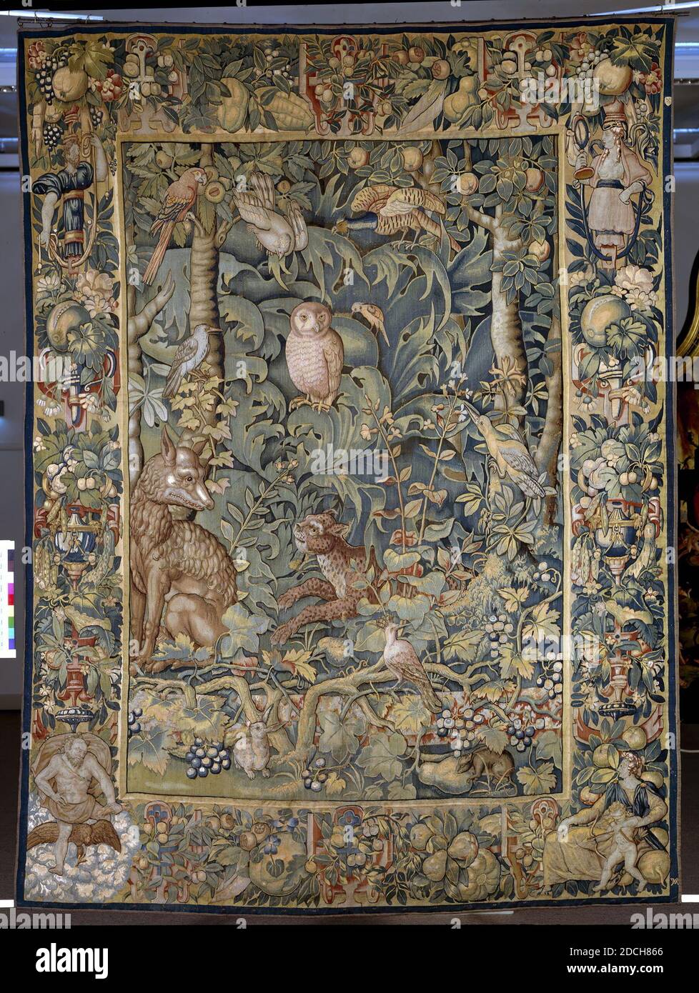 tapestry, Willem Andriesz. de Raedt, 1550 - 1558, woven, General: 312.5 x 231.5cm, cat, allegory, fox, rabbit, owl, cupid, venus, wolf, jupiter, lead, Painted room paneling with double doors, room paneling with one door and a mantelpiece, part of an 18th century interior. The paneling is made up of panels placed in frames which are provided with simple wood carvings. The compartments in both the single and double door paneling are lined with a modern yellow fabric. The chimney piece is also provided with rich wood carvings. The mantelpiece is made of gray marble, with a cut frame for a mantel Stock Photo