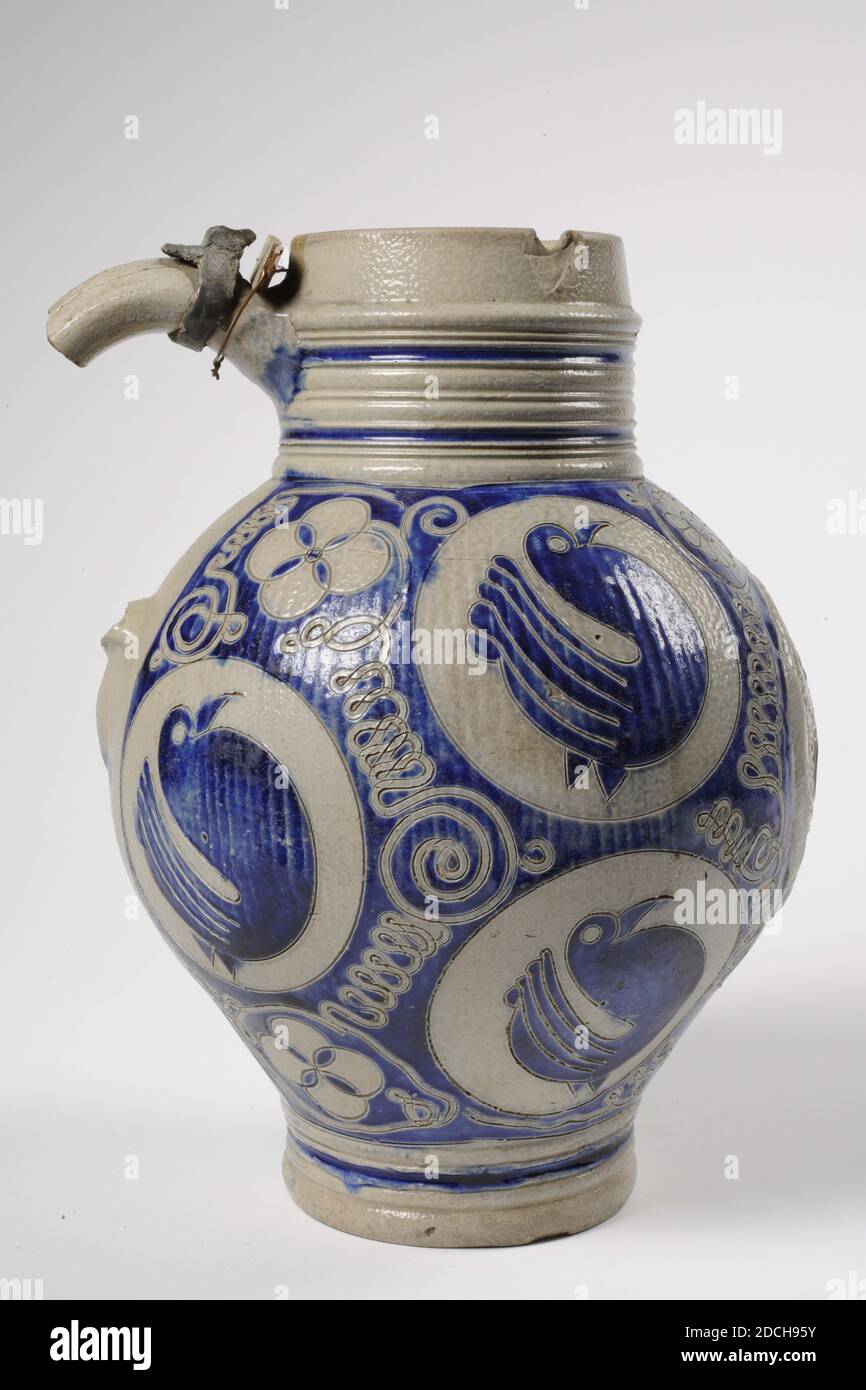 Jug, Anonymous, 18th century, stoneware, salt glaze, General: 25.4 x 20.2 x 18.5cm 254 x 202 x 185mm, Large gray stoneware jug, covered with a partly blue colored salt glaze. The jug has a narrow base with a flat bottom, a spherical belly and a wide, straight neck. The ear and tin lid are missing. In the center of the belly is an appliqué medallion with the letter GR [George Rex] with a crown on top and a bird underneath. Surrounded by six medallions with a carved bird decor and slotted motifs and floral motifs in between. Under the base of the ear is painted 1/2, bird Stock Photo