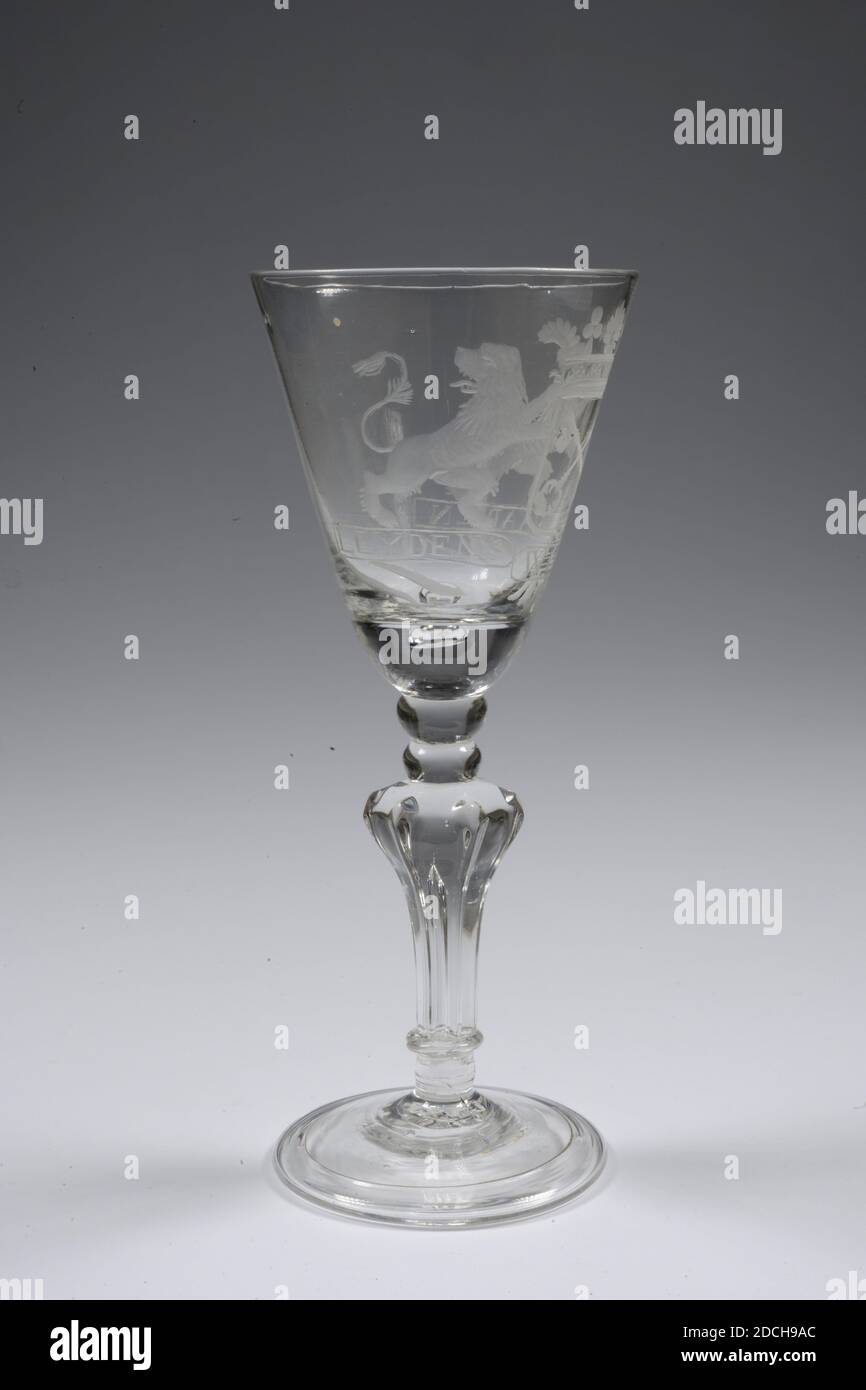 chalice, third quarter 18th century, General: 18.5 x 7.5cm 185 x 75mm, Base diameter: 6.8cm / Diameter chalice: 7.5cm, city coat of arms, lion, Chalice of colorless glass. The chalice has a slightly sloping base. A massive, baluster-shaped trunk known as the Silesian trunk in six vertical ribs ending in a point. An elongated bubble in the trunk. Above this two knots followed by a thick chalice bottom and the chalice. There is an air bubble in the chalice bottom. On the chalice wall an image of the coat of arms of Leiden, flanked by two lions with the caption: LEYDENS WEL VAAREN. The three Stock Photo