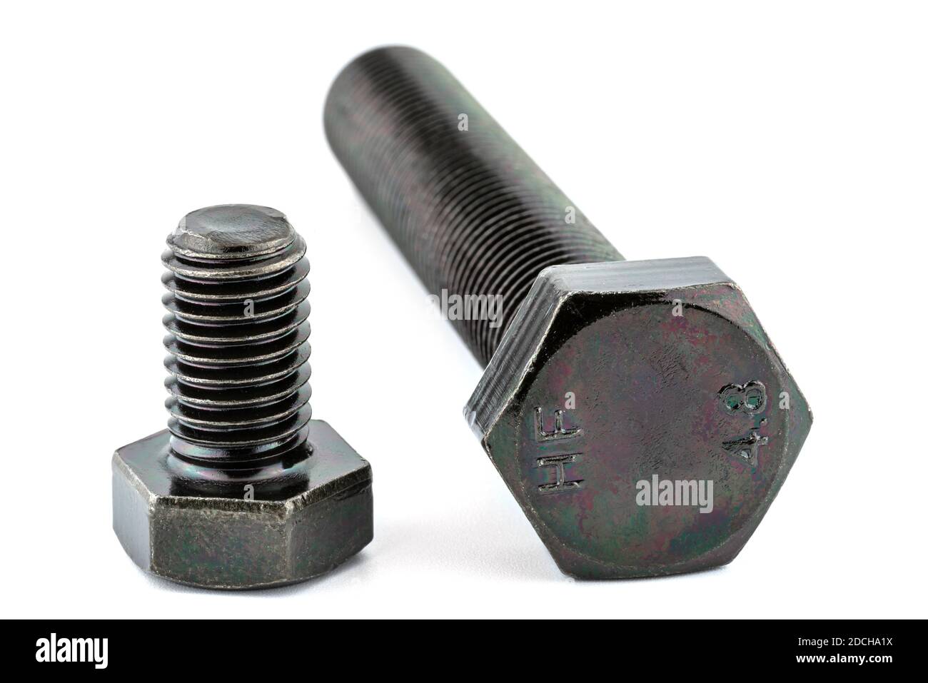 A background made of a macro shot of a black HF bolt thread with a hardness of 4.8, isolated on a white background, visible large and small bolt. Stock Photo