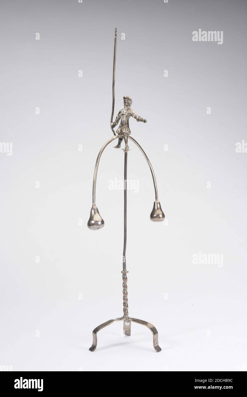 miniature toy, Anonymous, 1788, General: 19.5 x 6.5 x 4cm 195 x 65 x 40mm, Two-piece object, consisting of a balance and a stand. The balance artist sits on a semicircular arch, which ends in a pear shape on both sides. He has a stick in the left hand, the right hand is extended to maintain balance. The accompanying stand is on a tripod. The bottom part is twisted, the top, narrower part is smooth. The object is at the top of the rounding, at the level of the balance, marked, 1972 Stock Photo