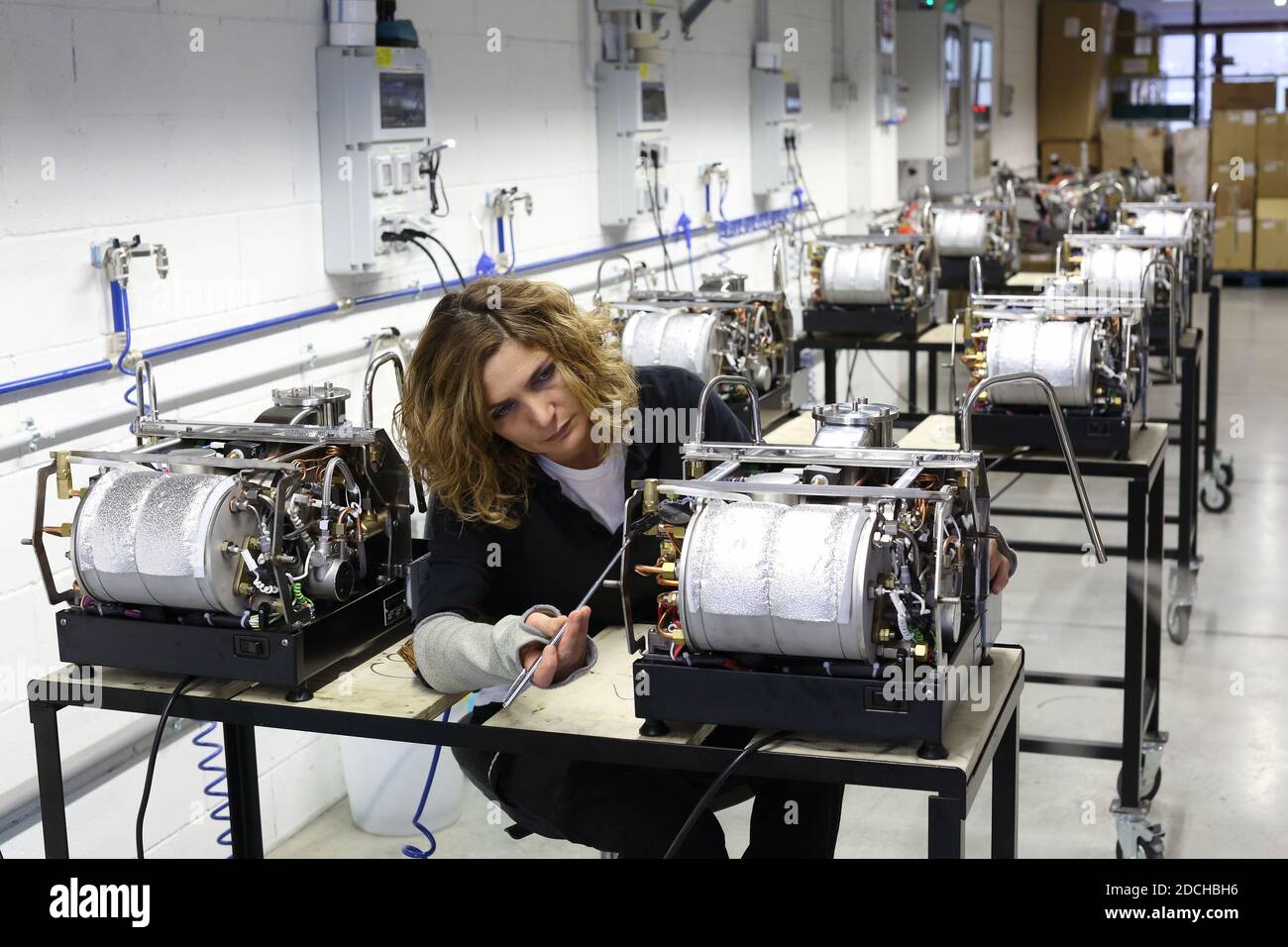 Female employee at the La Marzocco factory working on espresso machine ,Scarperia, Florence ,Italy Stock Photo
