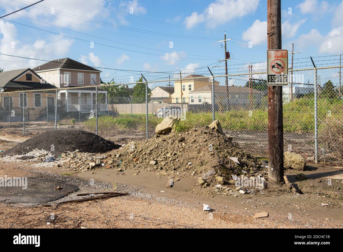 trash dumped on road with ironic no dumping sign in New Orleans