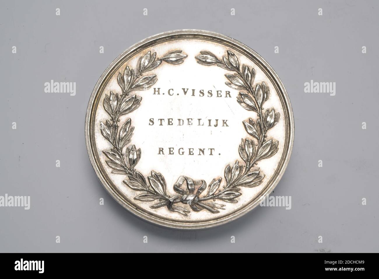 medal, Anonymous, 1853, Silver medal in 1853, honored to H.C. Fisherman as urban rain of poor. A three-line inscription is engraved on the front within a laurel wreath: H.C. VISSER STEDELIJK REGENT .. On the back an eight-line inscription in relief: MEMORIES FOR PROVEN SERVICES AS REGENT DER H.Z. AND D. ARMEN VAN LEIJDEN 1848 TO 1853, General: 4.2 x 0.3cm (42 x 3mm), Weight: 31.7g Stock Photo