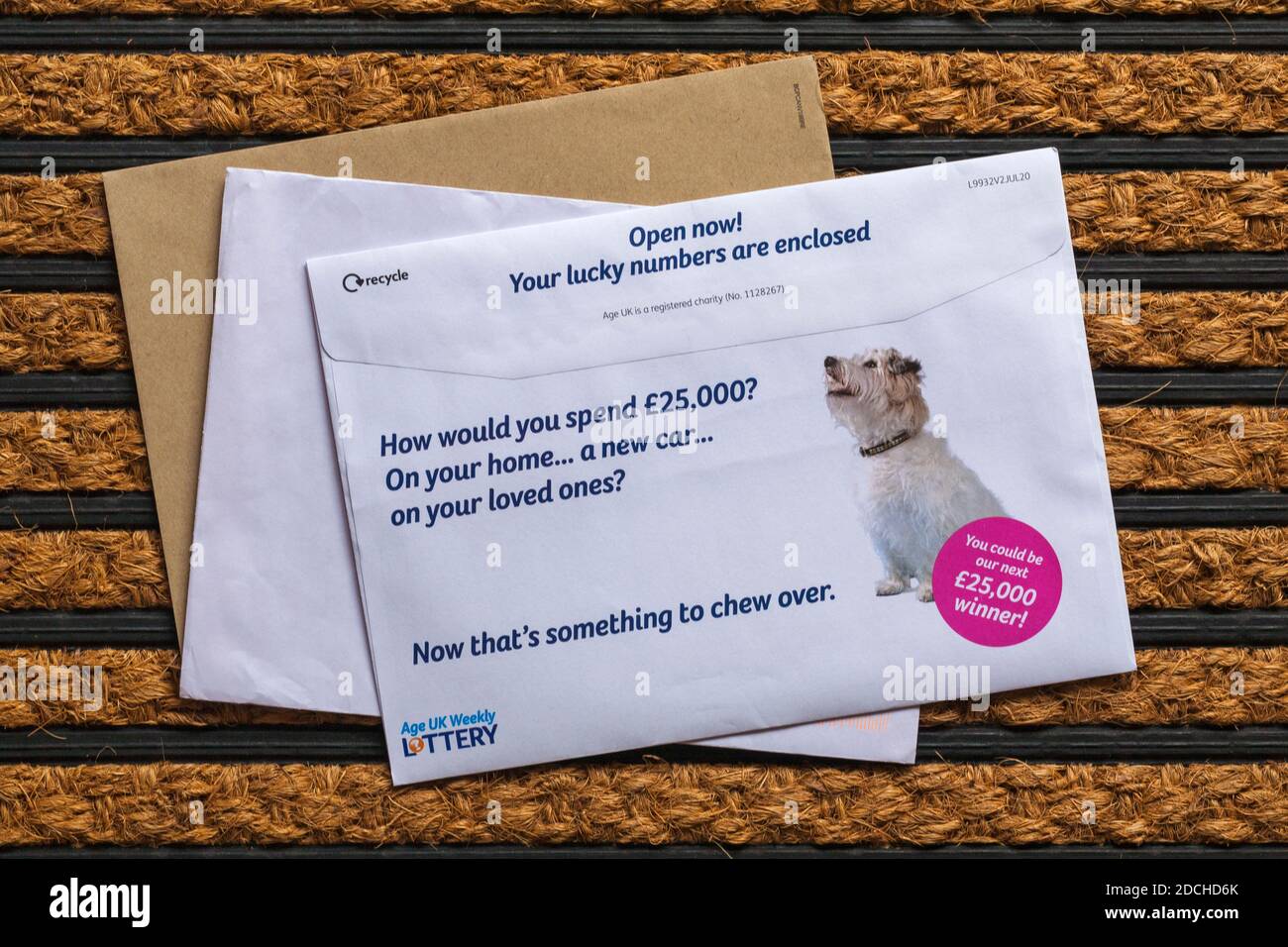 Post mail on doormat - Age UK weekly lottery Stock Photo