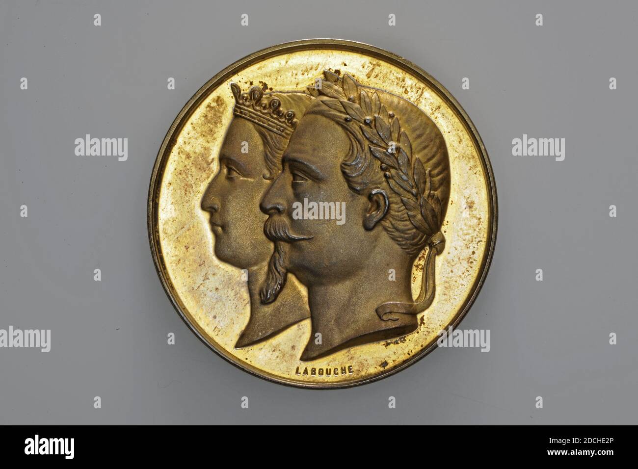 prize medal, Labouche, 1867, General: 5 x 0.3cm (50 x 3mm), Weight: 47.8g, double portrait, building, male, female, Gilded silver prize medal, minted for the Paris World's Fair, 1867. On the obverse the heads of a male figure and a female figure: Emperor Napoleon III and the Empress, both facing left, depicted one behind the other. Napoleon III wears a small beard and mustache and has a laurel wreath on his head. The empress is wearing a crown. Under the headings is LABOUCHE. On the reverse is the entrance to the exhibition, with flowing streamers. Human figures are depicted in front of the Stock Photo