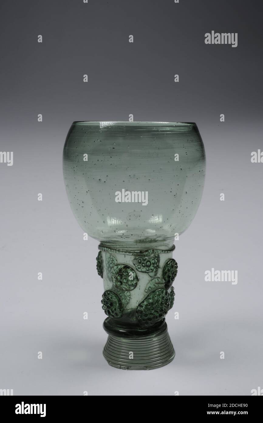 roemer, Anonymous, 18th century, blown, Roemer of light green colored glass. The rummer has a high, hollow, wire-glass wound base ending in a pointed soul in a hollow trunk. Eight blackberry studs on trunk. On the transition to the curved chalice, a fluted edge. In the chalice air bubbles, General: 15.4 x 7cm (154 x 70mm), Base diameter: 5.1cm / Diameter chalice: 5.5cm Stock Photo