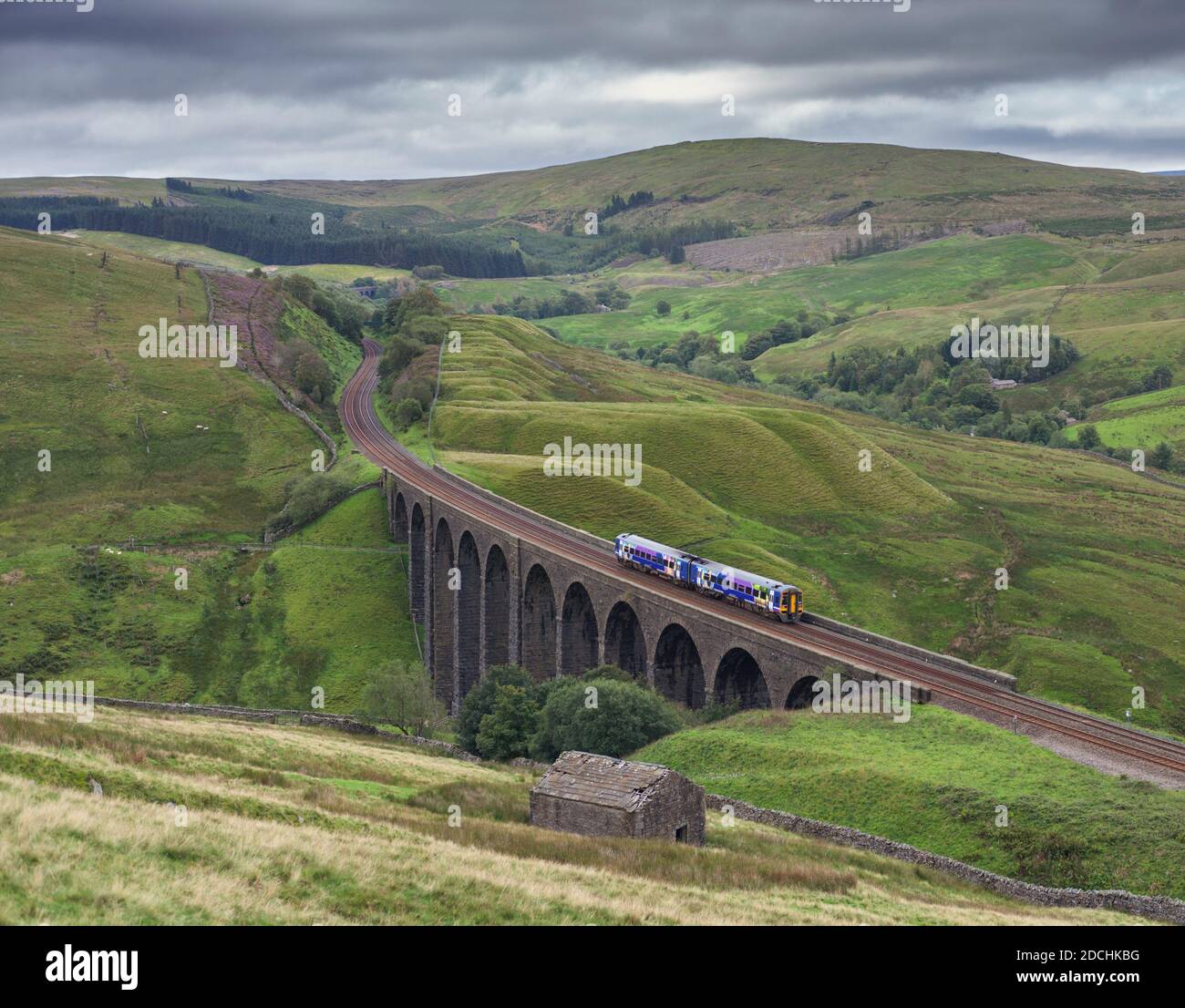 Northern Rail class 158 express sprinter train crossing Arten Gill viaduct in the landscape on the scenic Settle to Carlisle railway line Stock Photo