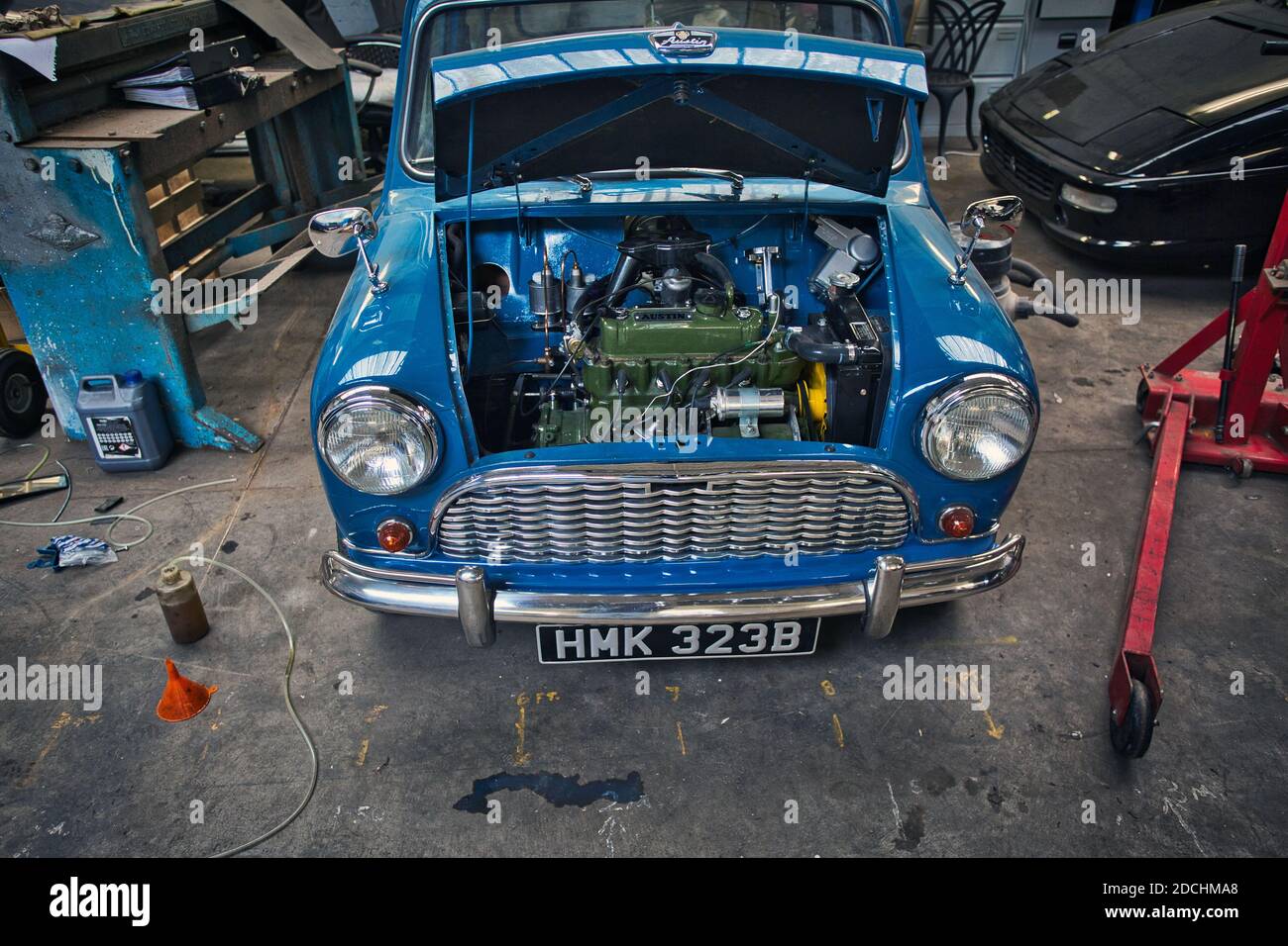 1960's Morris car partly taken apart/stripped down for restoration in a domestic garagewith bonnet open showing the Austin-Morris A-Series engine. Stock Photo