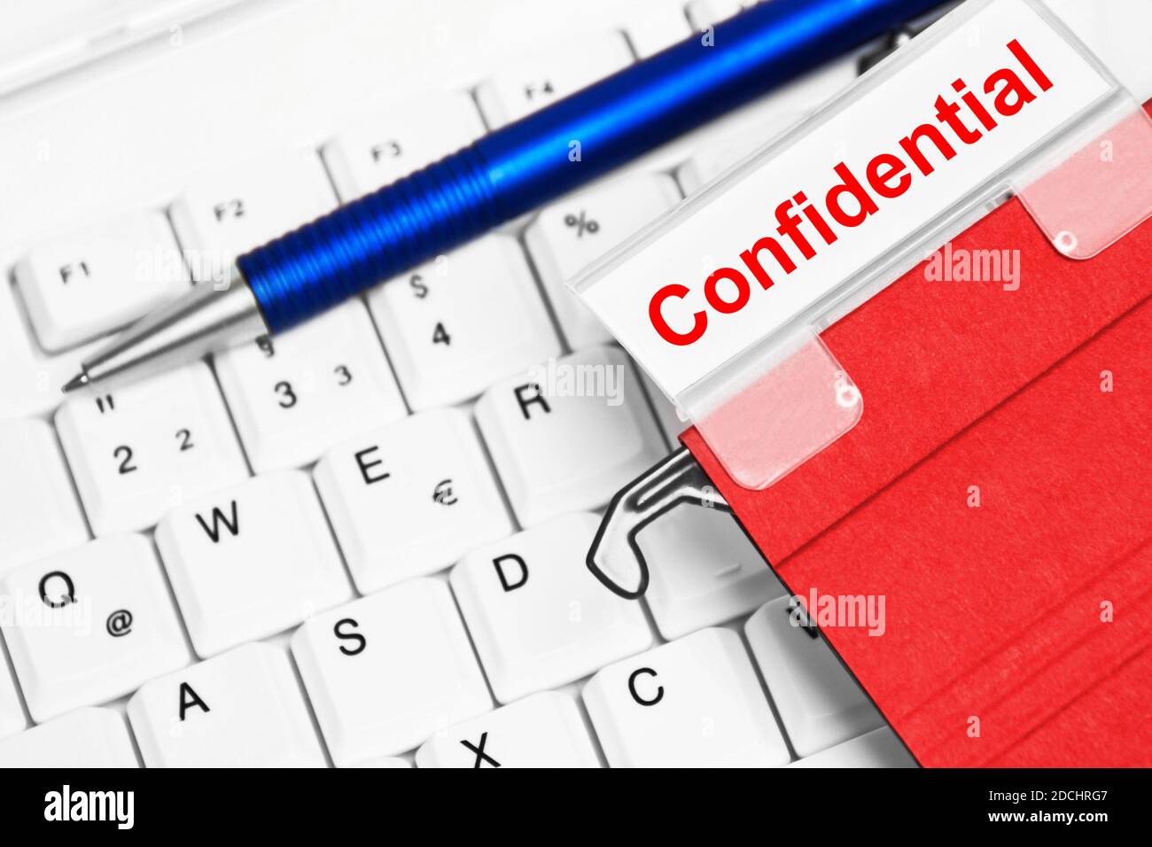 Debts red folder and white PC keyboard Stock Photo