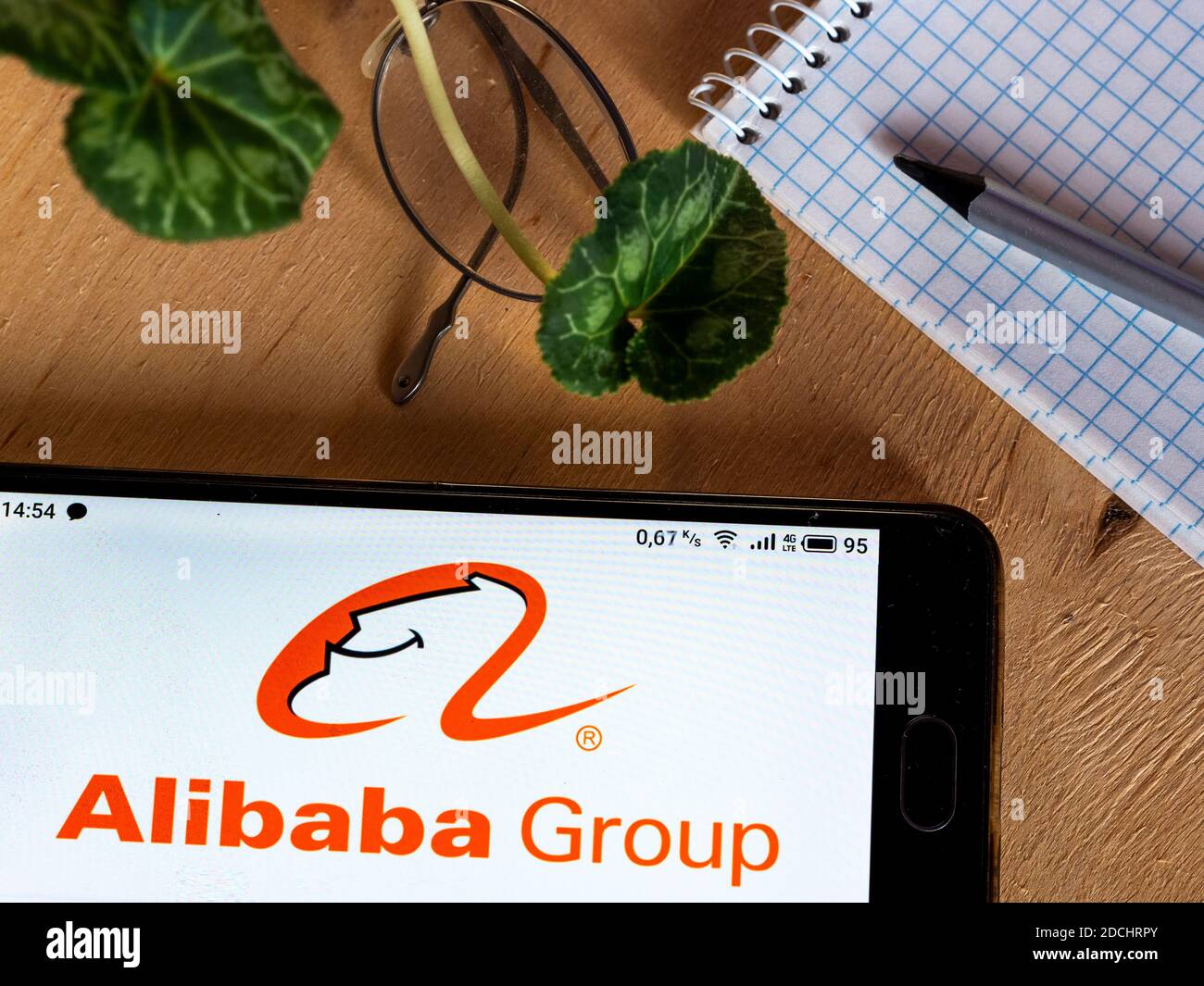 In this photo illustration an Alibaba Group logo seen displayed on a
