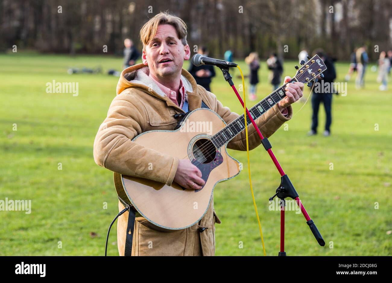 Munich, Bavaria, Germany. 21st Nov, 2020. Christian Stockmann of Christen im Widerstand sings at a corona rebel ''church service''. Bypassing a ban on ''Hygienedemos'' in Munich, the Coronarebels organized as a church service (Gottesdienst) that ultimately took place in the English Garden. The event was organized by multi-activist Frank Winkler who is associated with animal rights groups as well as Parents for Future, but more recently has been active since the beginning of the Corona conspiracy theory and anti-mask demonstrations, now moving up to the core of the organizational structure Stock Photo