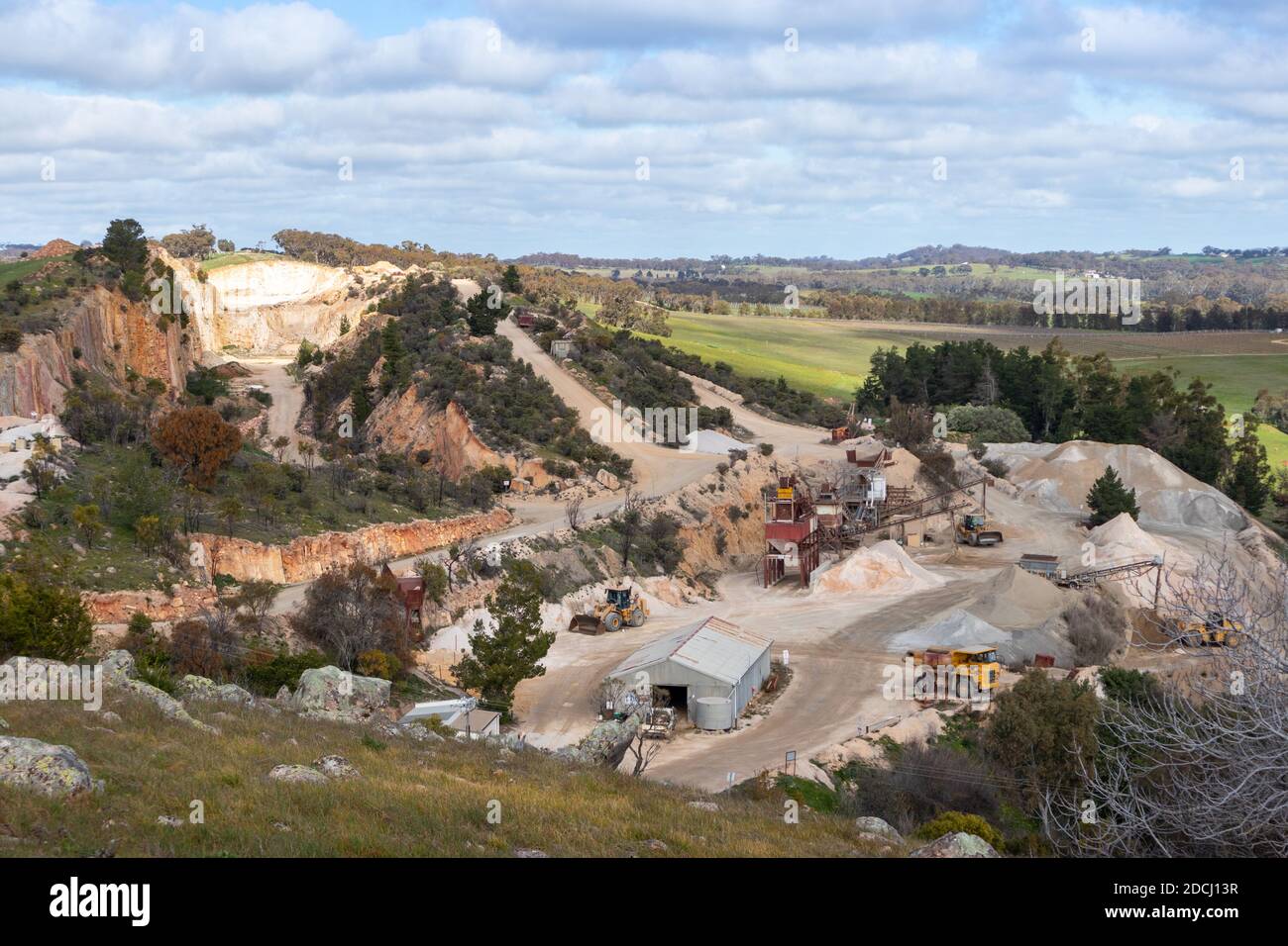 Trucks and machinery working at a stone quarry, exploitation of natural