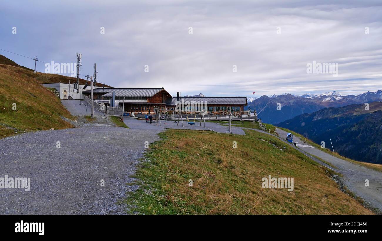 Mountain station with restaurant and terrace of cableway 'Schafbergbahn' in popular ski resort in the Rätikon mountains in autumn season. Stock Photo