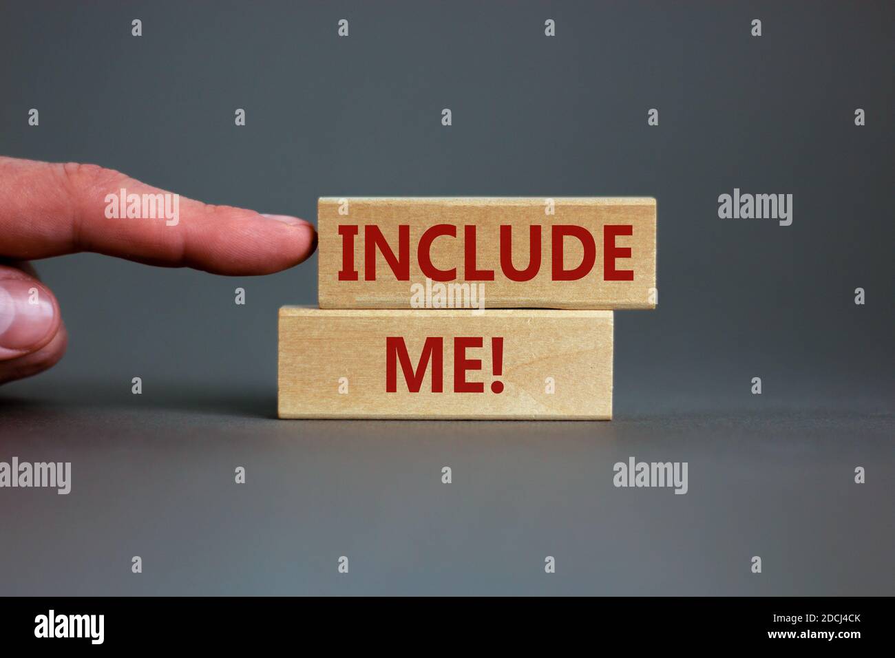 Wooden blocks with words 'include me' on beautiful grey background ...