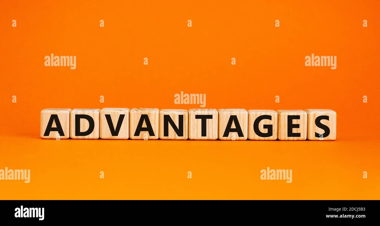 Concept word 'advantages' on wooden cubes on a beautiful orange background. Business concept, copy space. Stock Photo