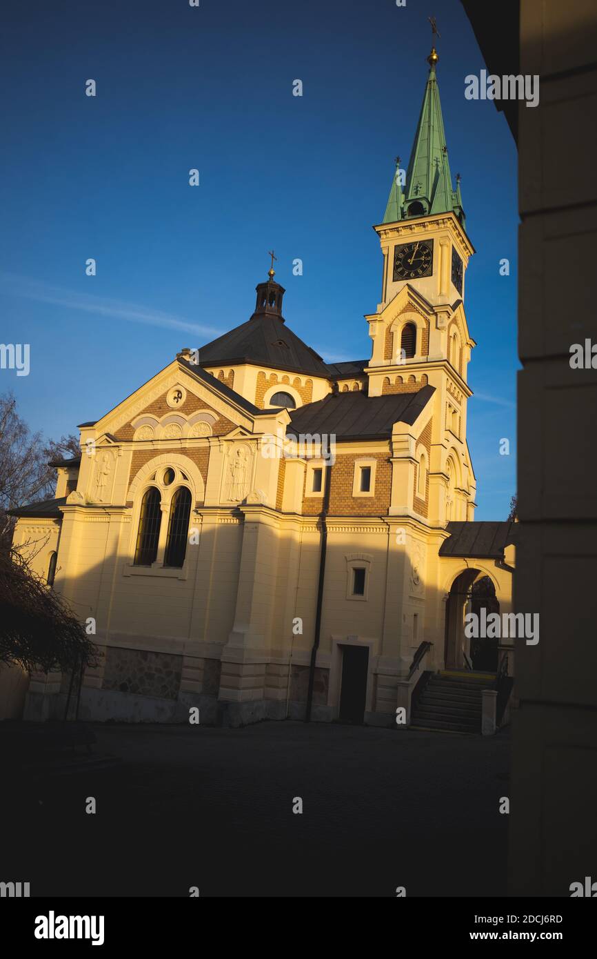 Czech Republic, 11/21/2020: Cemetery church, half lit half in the shade Stock Photo