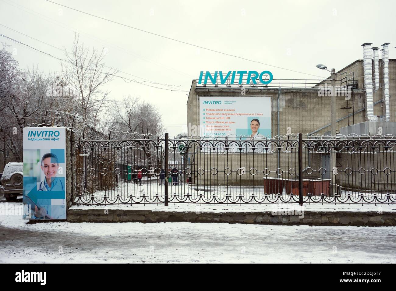 Invitro Clinic with an information banner on the wall and an advertising poster on the fence in Novosibirsk. Russia. Stock Photo