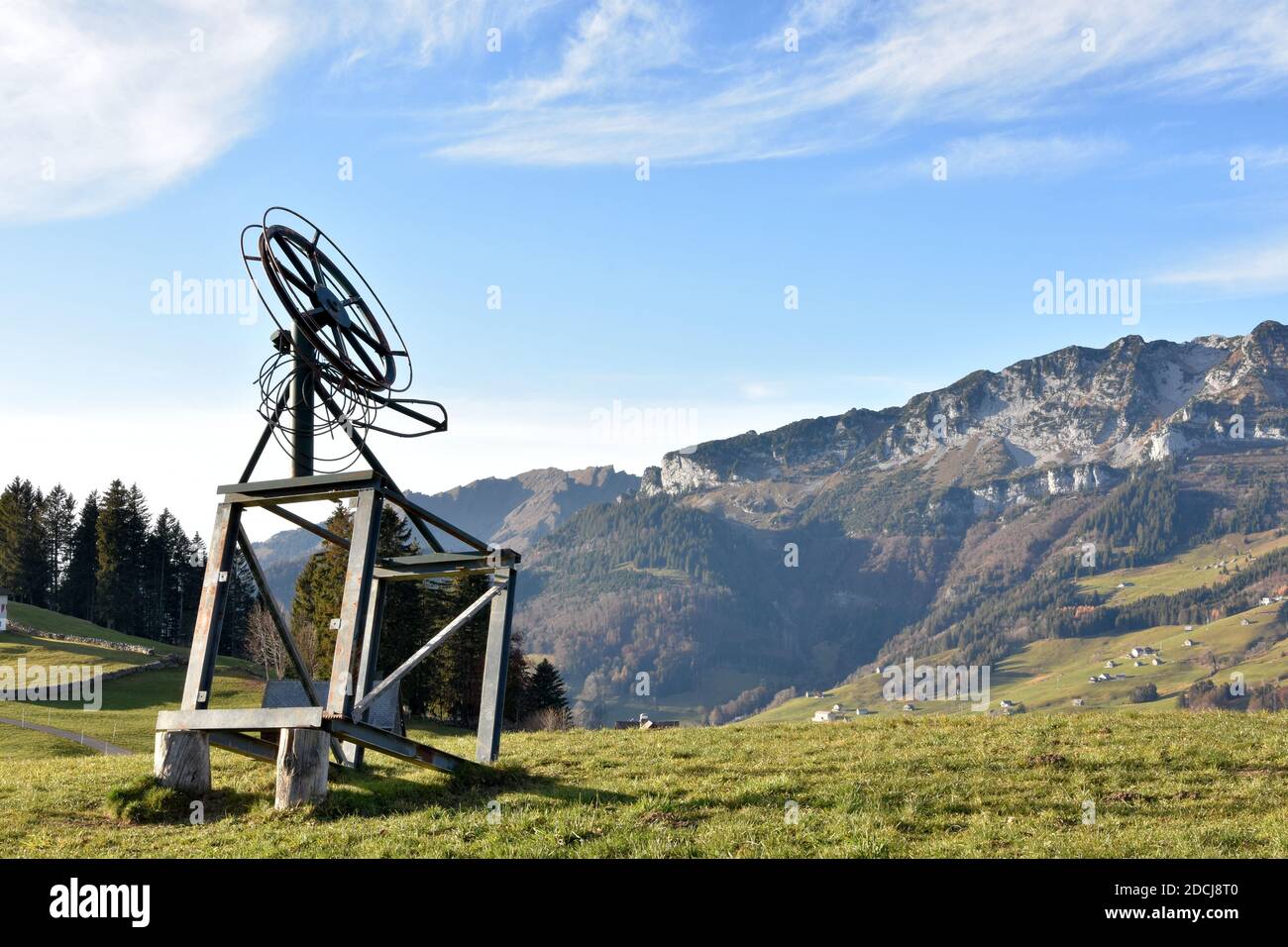 A small ski lift out of service in late autumn on the top of a slope in Amden, a tourist and ski resort in eastern Switzerland. It is waiting for snow. Stock Photo