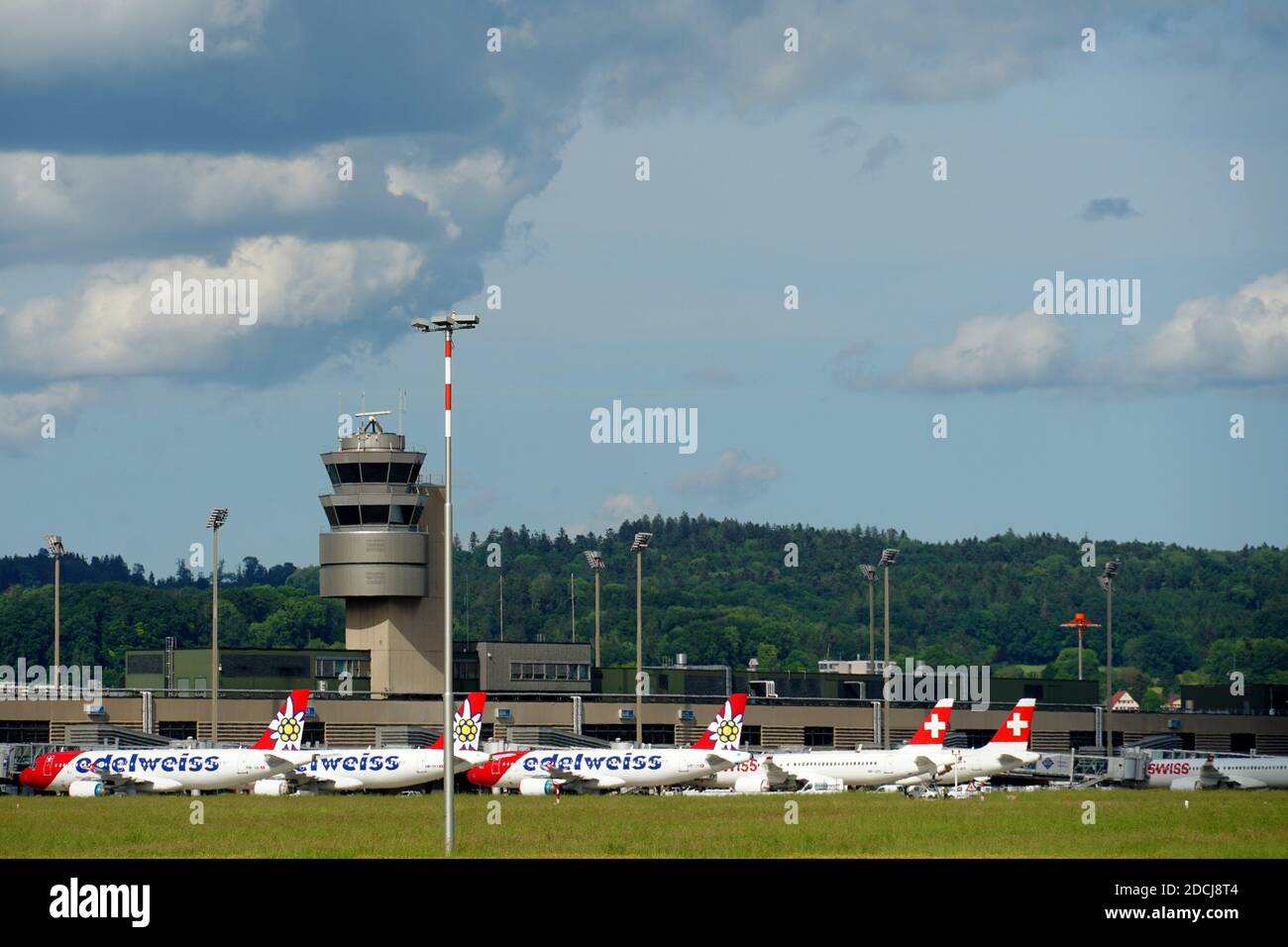 Control tower of airport Zurich in Switzerland. There are still standing airplanes as well since the transport after lockdown in the spring. Stock Photo