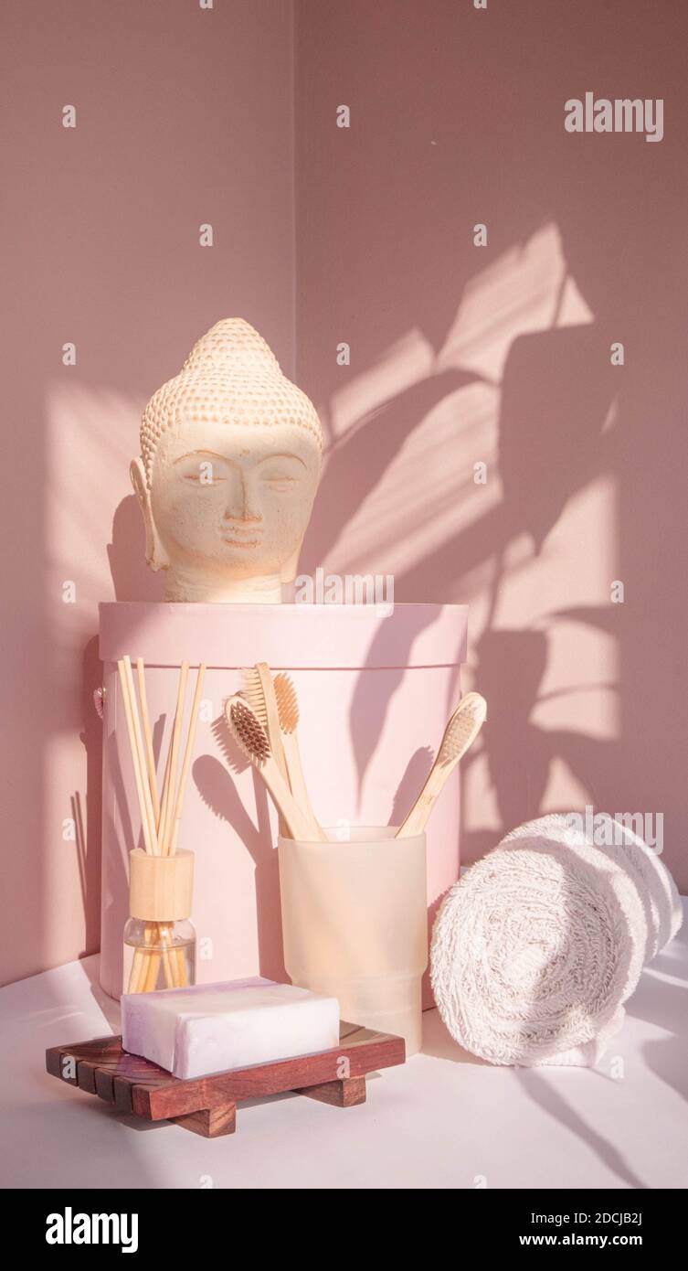 White Buddha bust on pastel pink background Stock Photo