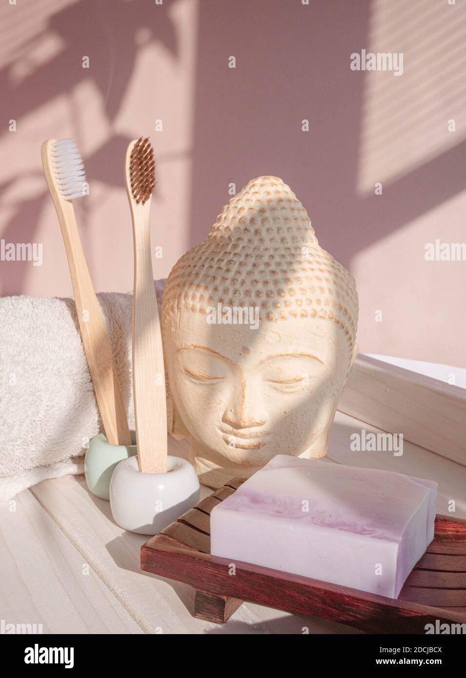White Buddha bust on pastel pink background Stock Photo