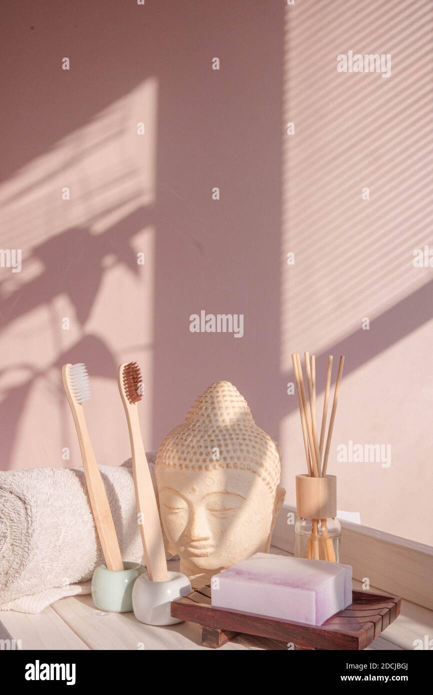 White Buddha bust on pastel pink background Stock Photo