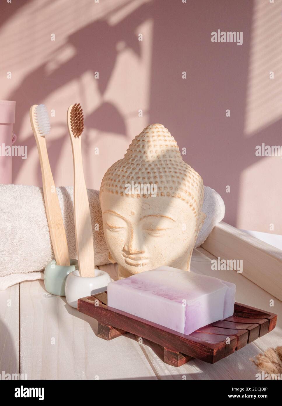 White Buddha bust on pastel pink background Stock Photo