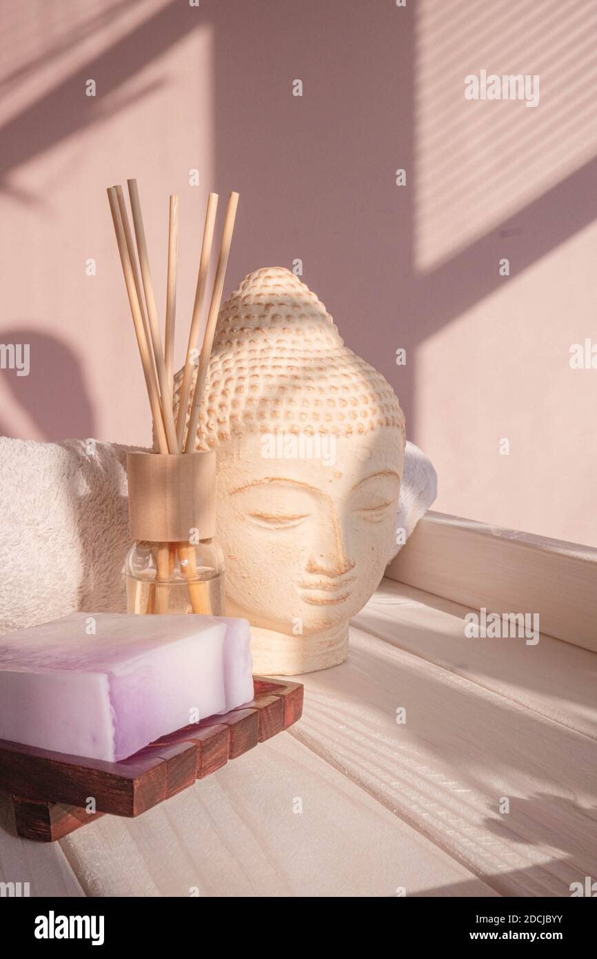 White Buddha bust on pastel pink background Stock Photo