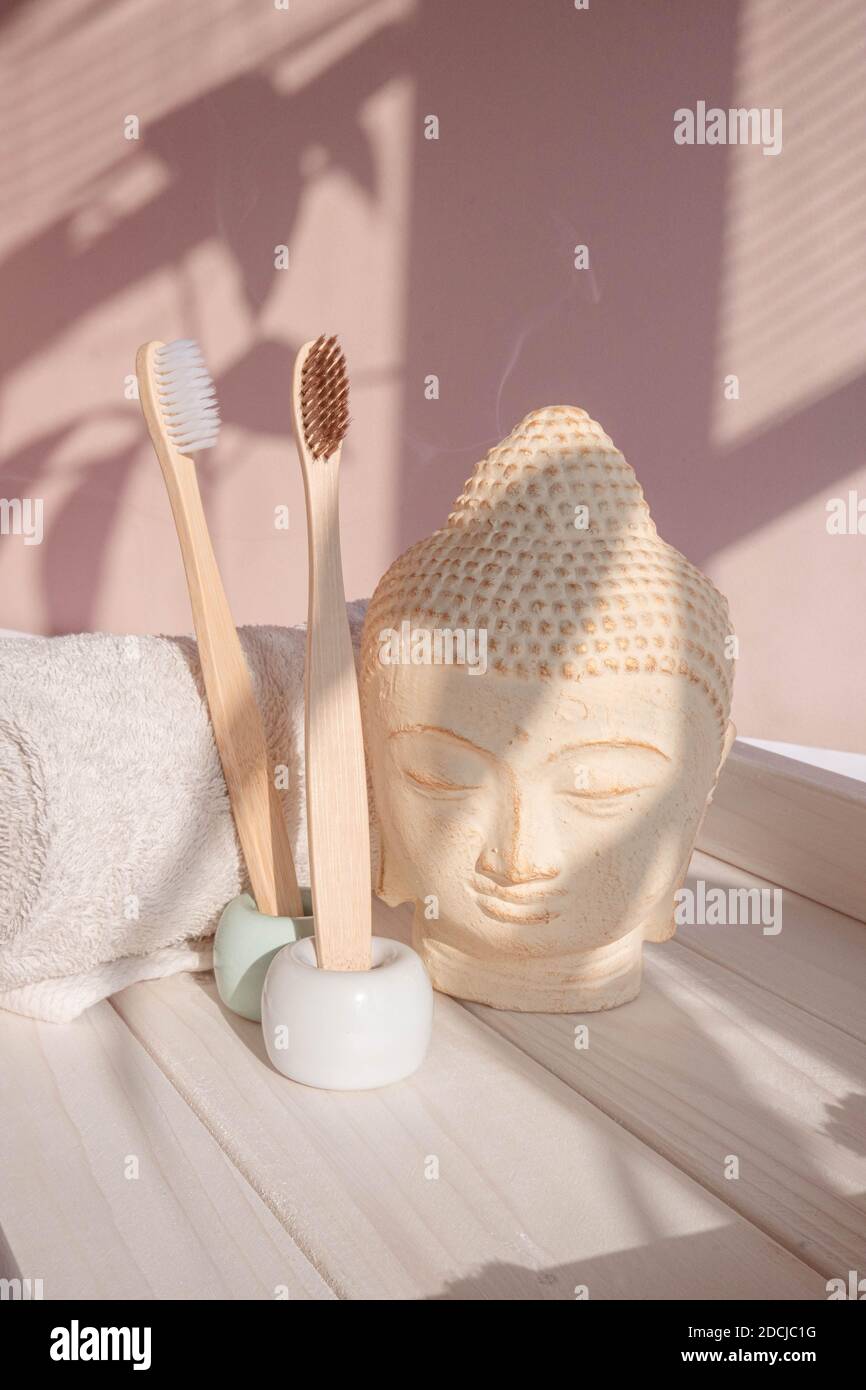 White Buddha bust on pastel pink background Stock Photo
