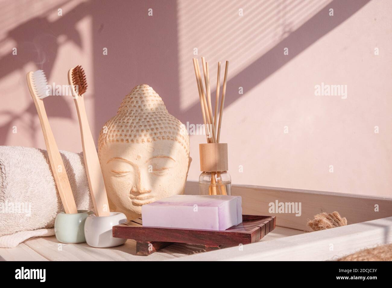 White Buddha bust on pastel pink background Stock Photo