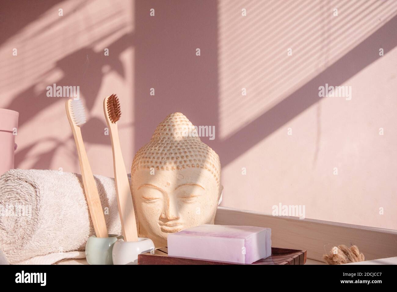 White Buddha bust on pastel pink background Stock Photo