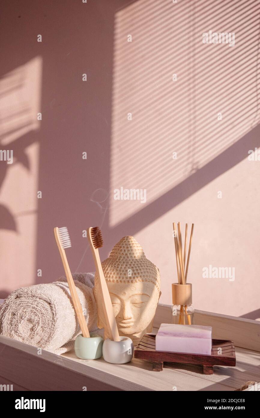 White Buddha bust on pastel pink background Stock Photo
