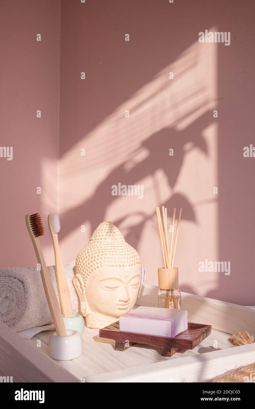 White Buddha bust on pastel pink background Stock Photo