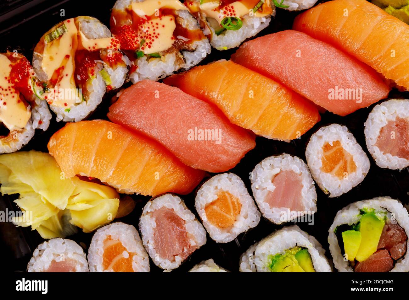 https://c8.alamy.com/comp/2DCJCMG/japanese-delicious-fresh-sushi-roll-set-on-a-black-tray-japanese-food-top-view-2DCJCMG.jpg