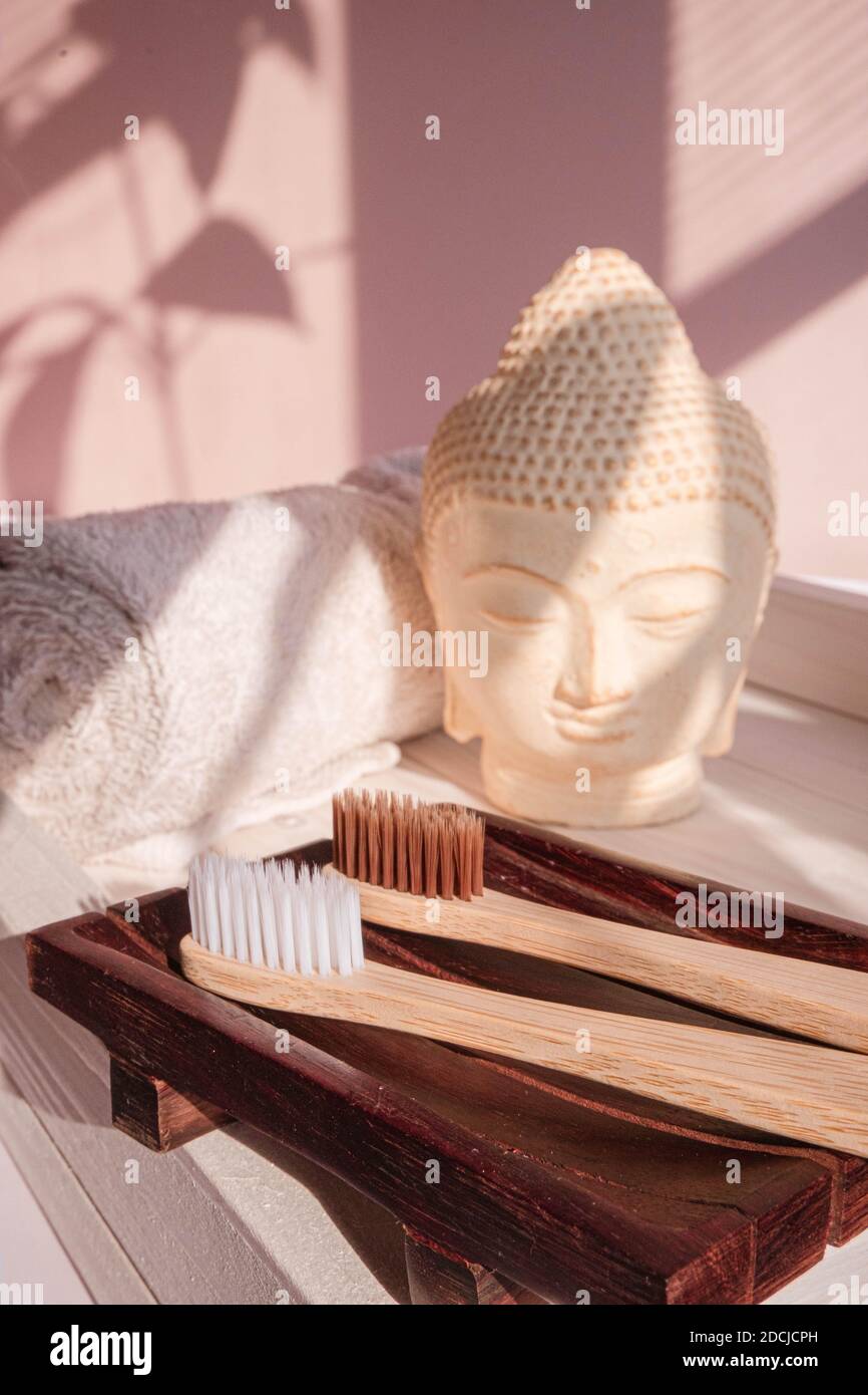 White Buddha bust on pastel pink background Stock Photo