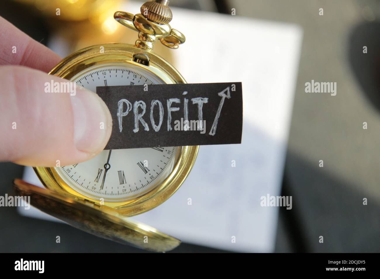 Profit growth concept. Inscription and gold pocket watch. Stock Photo