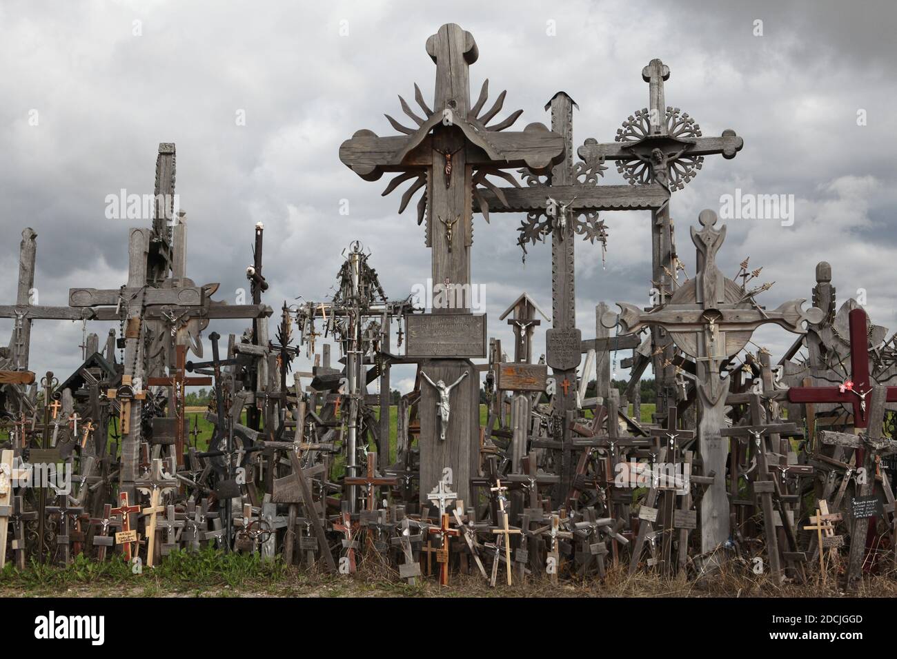 Wooden crosses on the Hill of Crosses near Šiauliai in Lithuania. The most important Lithuanian pilgrimage site is located some 12 km from the town of Šiauliai. Nobody has ever tried to count how many large and small crosses are actually installed on the hill, but it is believed there are at least two hundred thousand crosses here. And every day dozens or even hundreds of new crosses are added by pilgrims from all over the world. Stock Photo
