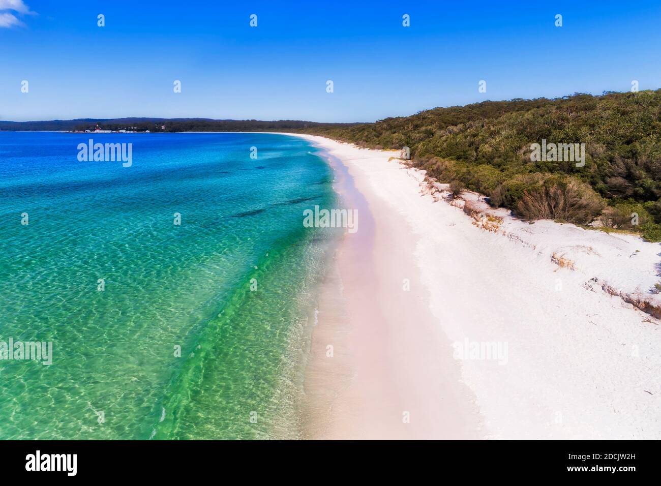 Smooth wave rolling on white sand dune of Hyams beach in Jervis bay - elevated aerial view. Stock Photo
