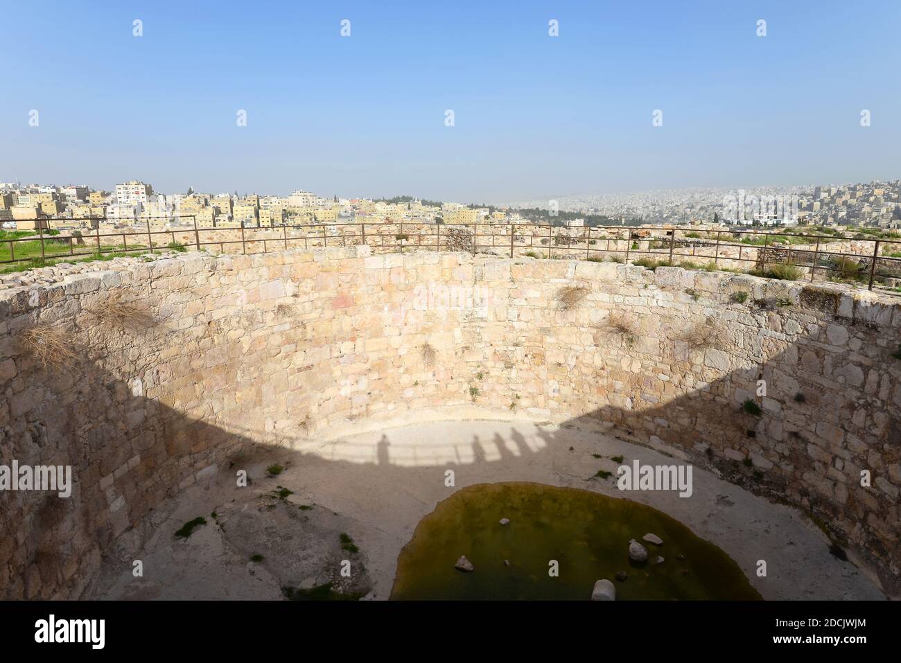 Huge water reservoir dug in the Citadel in Amman, Jordan. Ancient water tank built with stones. Location also know as Jabal Al-Qal'a. Stock Photo