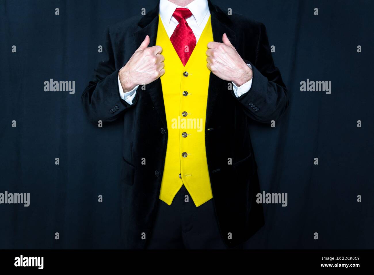 Portrait of Fancy Dressed Man in Velvet Jacket and Yellow Waistcoat With Hands on Lapels. Sartorial Style and Elegance. Groom on Wedding Day Stock Photo