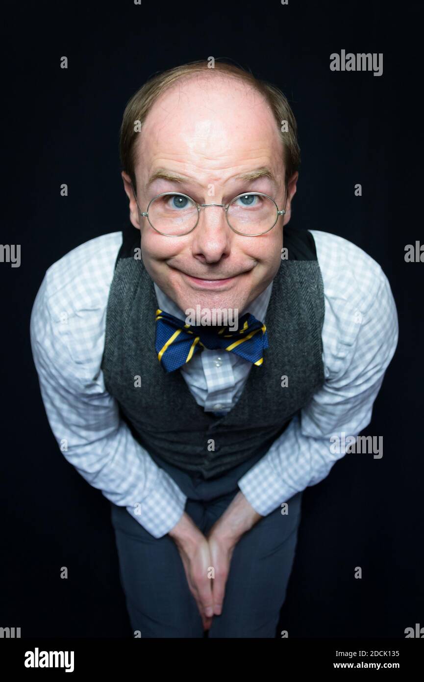 Portrait of Man in Tweed Waistcoat and Bow Tie Smiling Sweetly Stock Photo
