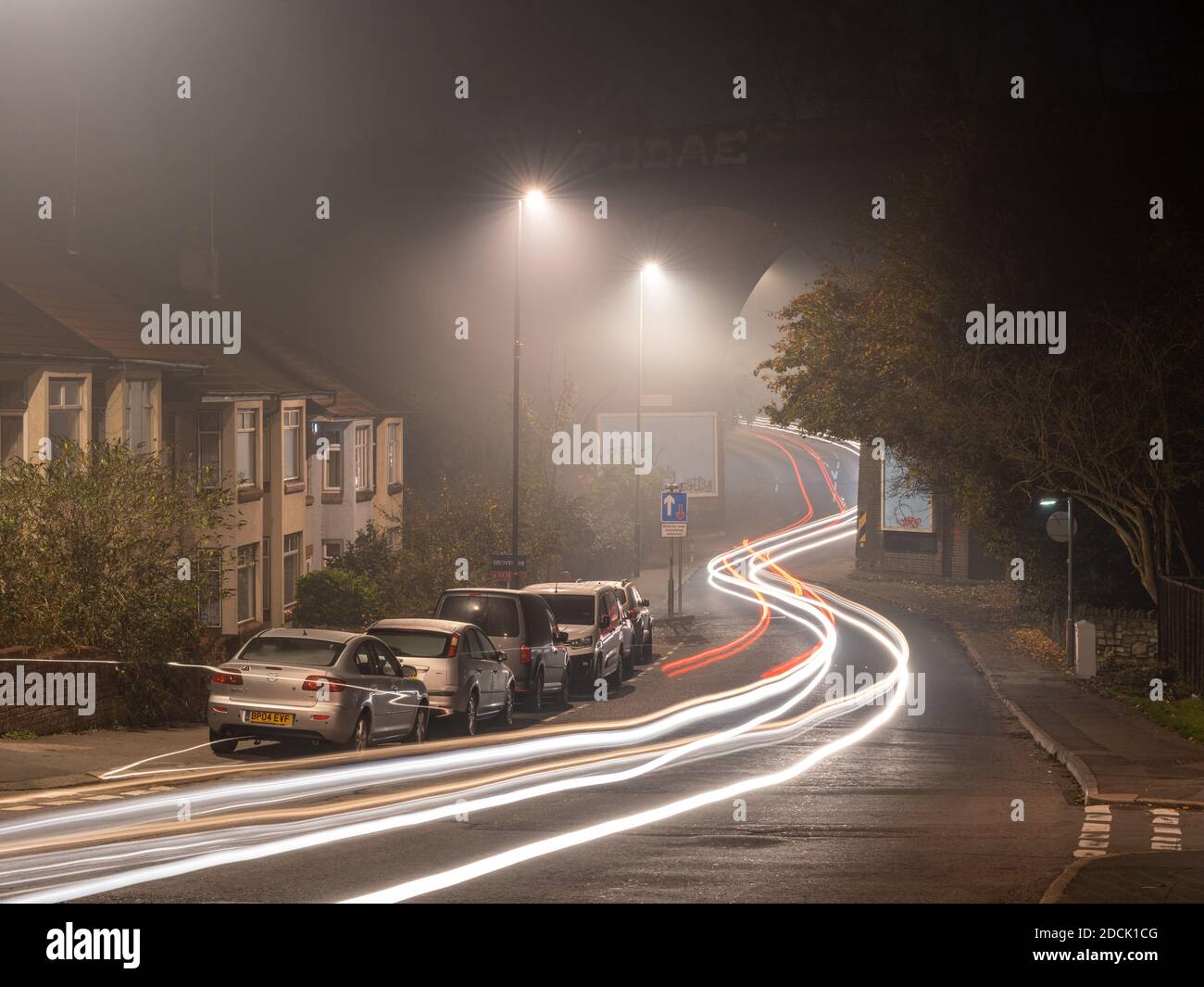 Traffic leaves light trails under the Royate Hill Viaduct on a misty night in Eastville, Bristol. Stock Photo