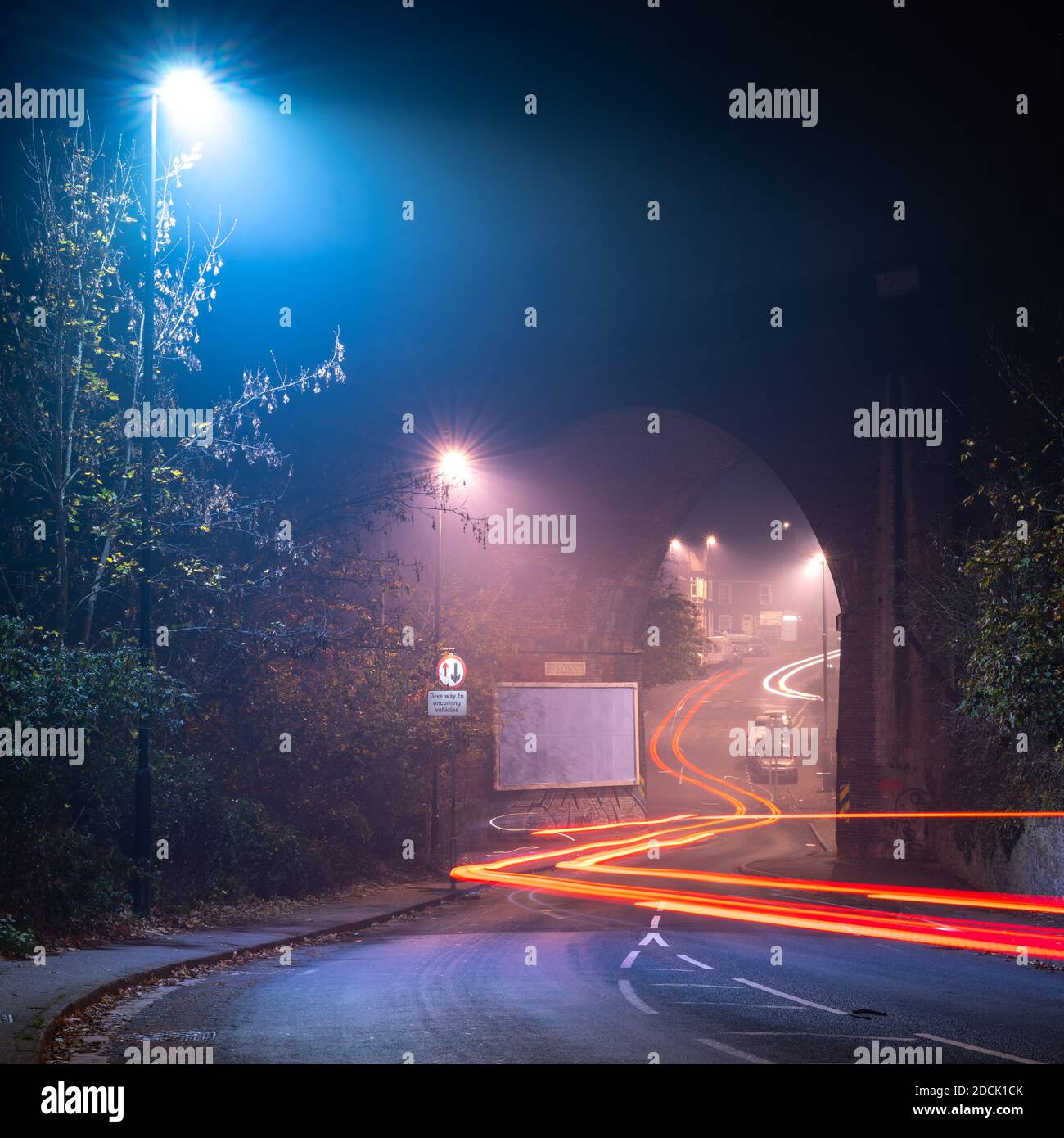 Traffic leaves light trails under the Royate Hill Viaduct on a misty night in Eastville, Bristol. Stock Photo